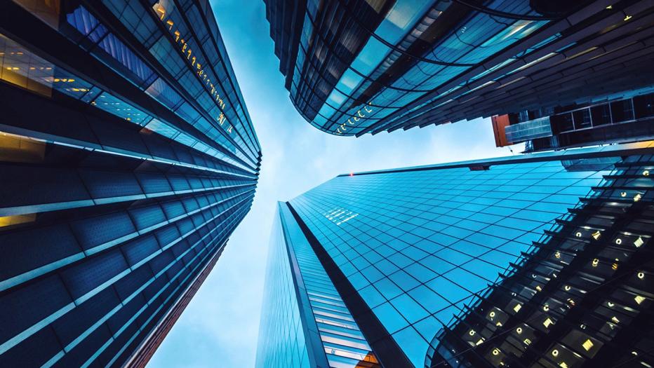 Looking up at three tall buildings