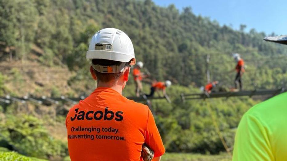 Member of the B2P looks on as team works on decking