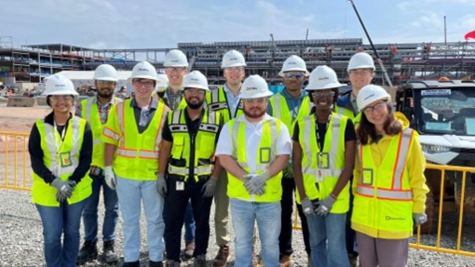 Jacobs interns in yellow PPE vests and white hardhats visit a project site