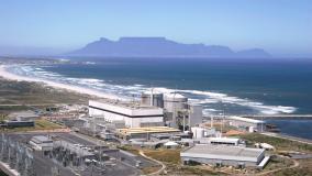 Aerial view of a power plant on the coast of a body of water