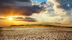 Stock image of a desert in drought with sunset