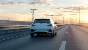 Car traveling toward sunset with wind energy