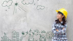 Young girl in a yellow hard hat in front of a green sketch of city and transportation