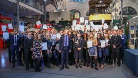 Group of staff posed outside the London Transport Museum
