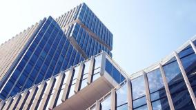 Stock image of skyscrapers with glass windows top to bottom