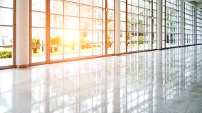 Empty lobby with glass windows and sun coming through