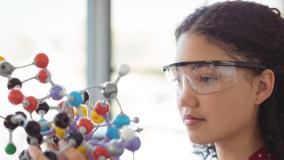 Girl holding scientific model