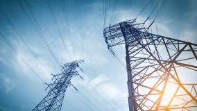 looking upwards from the base of 2 electric pylons