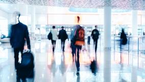 Motion Blur of People Walking in modern corridor with glass and steel