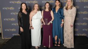 Five women in formal dress with their award at ACEC