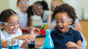 Young verse girl children doing a science experiment