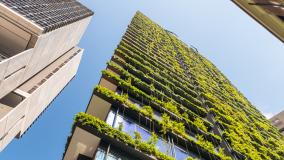 Skyscraper with green vegetation along balconies