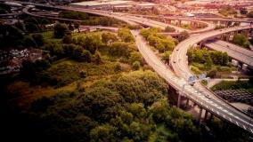 Aerial view of bridges with surrounding urban areas and green trees.