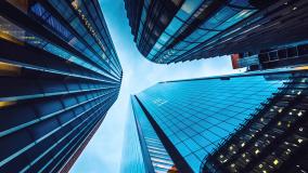 Looking up at three tall buildings