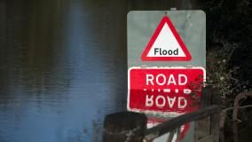 Flooded road with red "Flood" sign