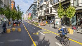 Pop-up bicycle lane in central Berlin with people biking, walking and relaxing. This is a trial concept for urban planning which improves the quality of life of people.