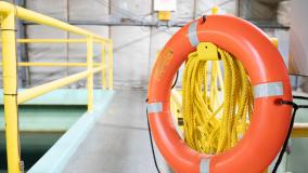 Orange life preserver hanging near a treatment pond