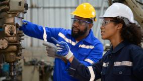 Both of engineers are consulting and exchanging repair experience with each other. about repairing old machines to return to normal operation.
