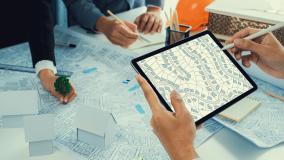 Worker, architect and engineer work on real estate construction project oratory planning with cartography and cadastral map of urban town area to guide to construction developer business plan of city