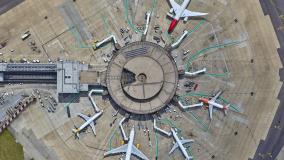 Aerial view of pier at airport with planes