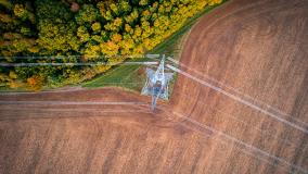 Aerial view of electricity pylon in field
