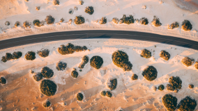 Birds eye view of a road running through a desert landscape