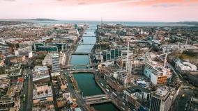 Aerial view of river running through Dublin with buildings and bridges