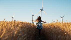 Girl running through a wheat field