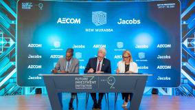 Three people signing a document