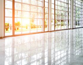 Empty lobby with glass windows and sun coming through