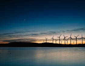 Wind turbines over water at night