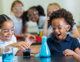 Young verse girl children doing a science experiment