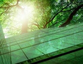 Sustainble green building. Eco-friendly building. Sustainable glass office building with tree for reducing carbon dioxide. Office with green environment. Corporate building reduce CO2. Safety glass.