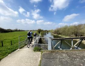 Two cyclist o a tow path along the River Stort in Hertfordshire. May 2023
