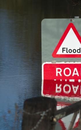 Flooded road with red "Flood" sign