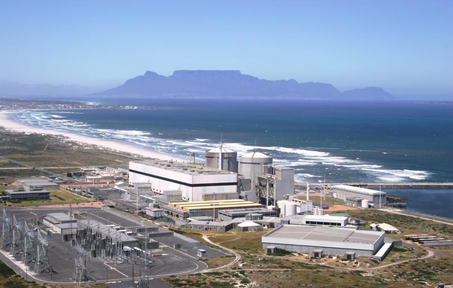 Aerial view of a power plant on the coast of a body of water