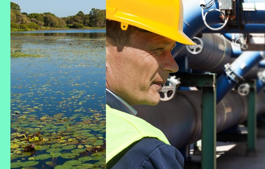 Stock image banner with natural body of water, man in yellow hard hat in front of operational machine and abstract view