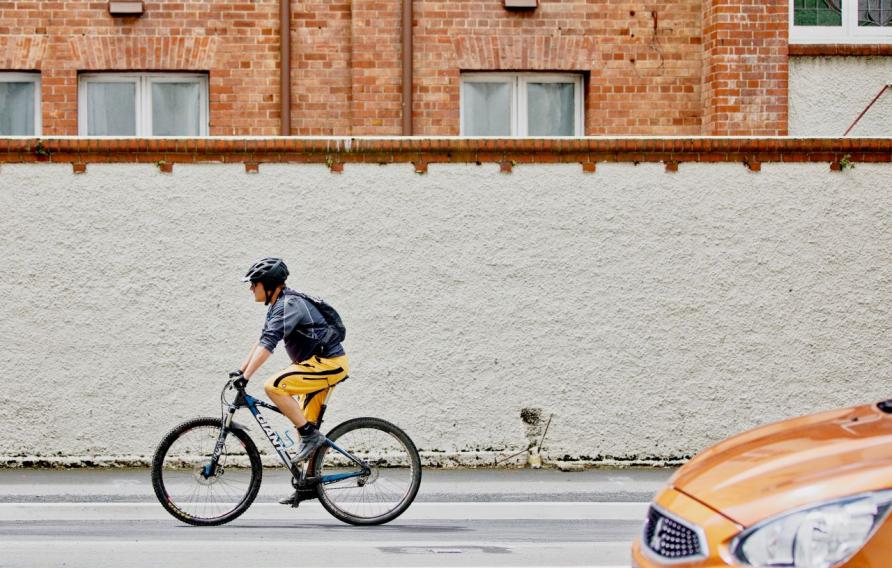 Man cycling right to left across the screen