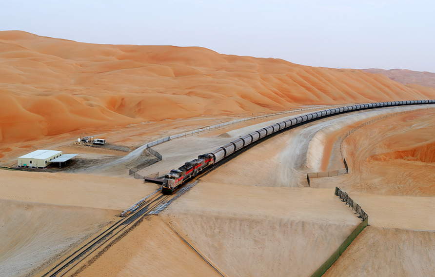 Etihad Rail - train driving between gorgeous orange sand dunes