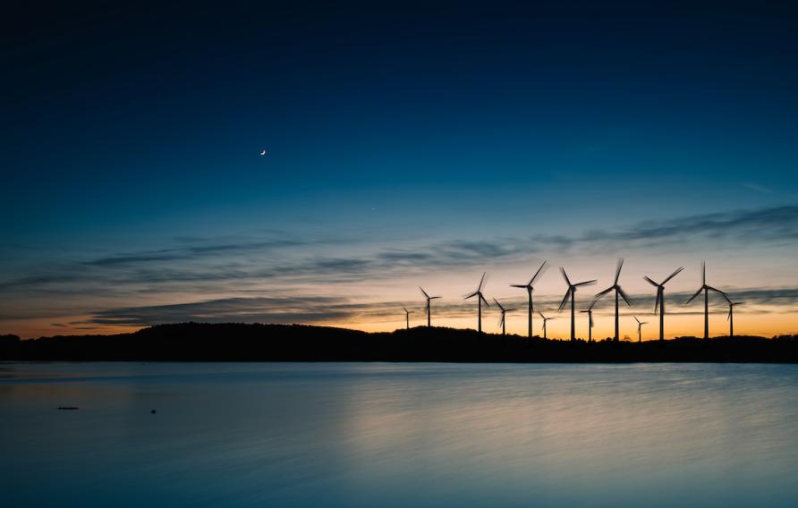 Wind turbines over water at night