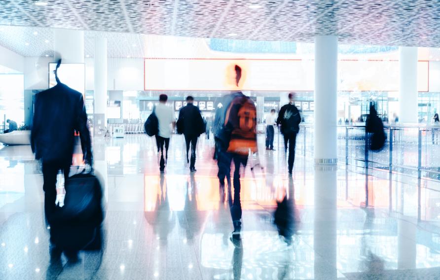 Motion Blur of People Walking in modern corridor with glass and steel