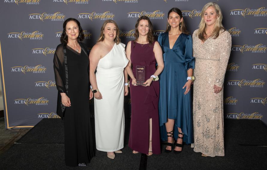 Five women in formal dress with their award at ACEC