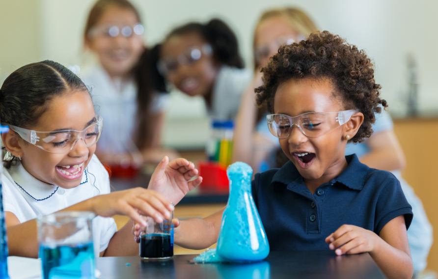 Young verse girl children doing a science experiment