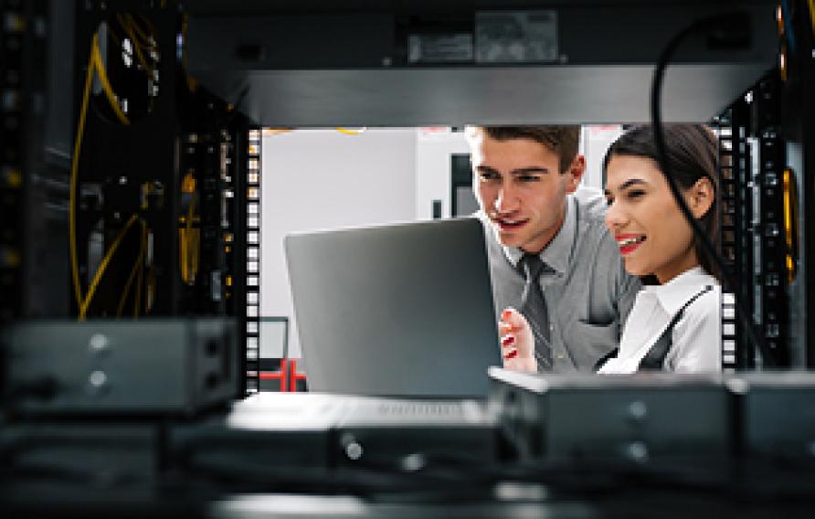 Man and woman looking at a computer