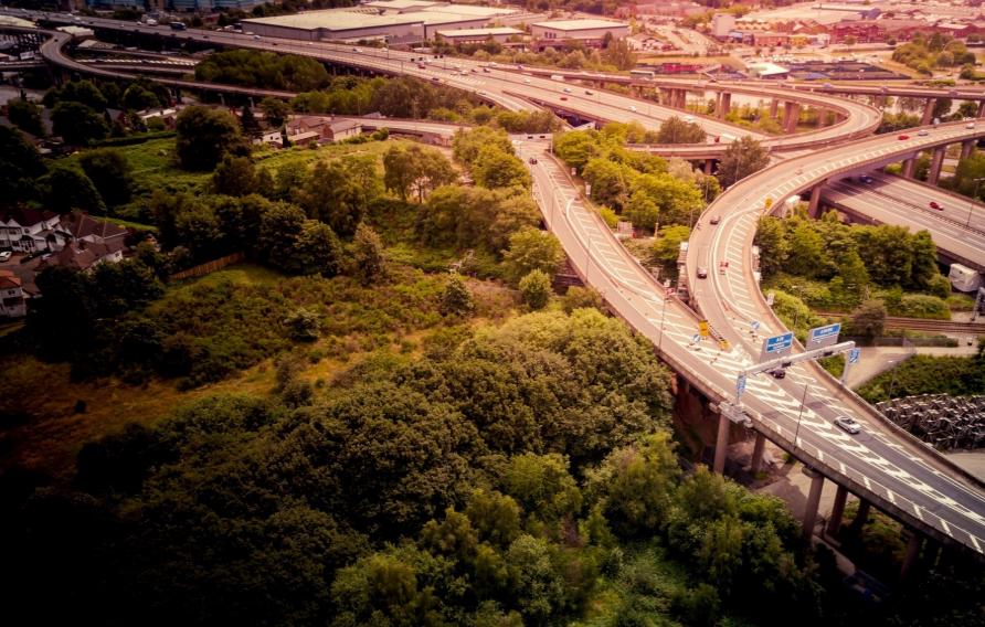 Aerial view of bridges with surrounding urban areas and green trees.