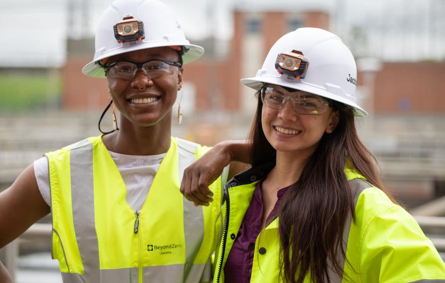 Two women engineers in PPE smile for the camera