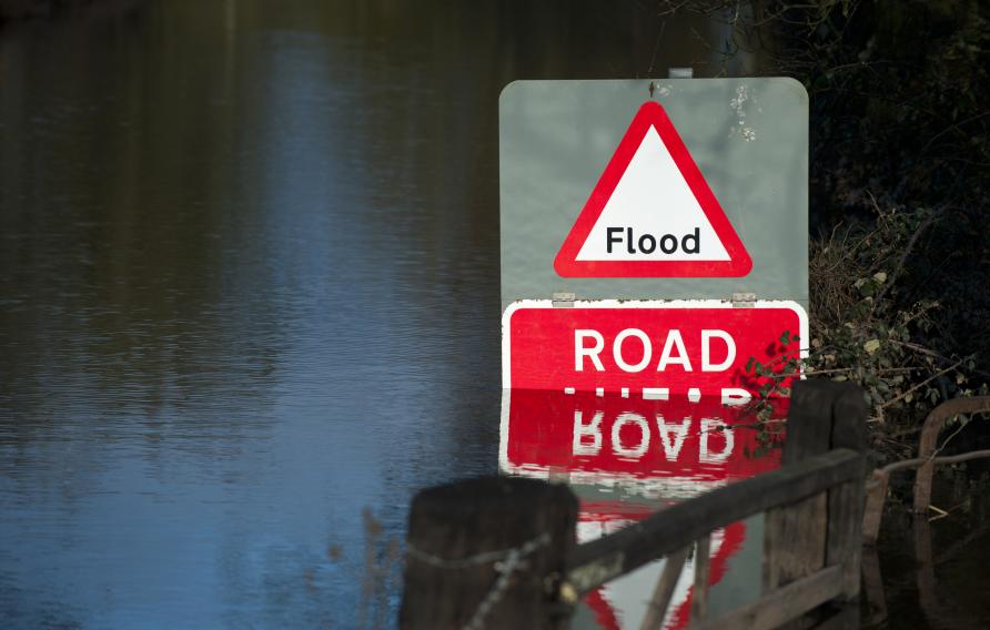 Flooded road with red "Flood" sign