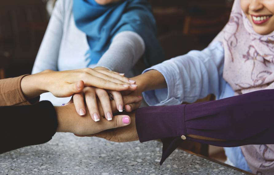 Islamic friends hands stack for teamwork