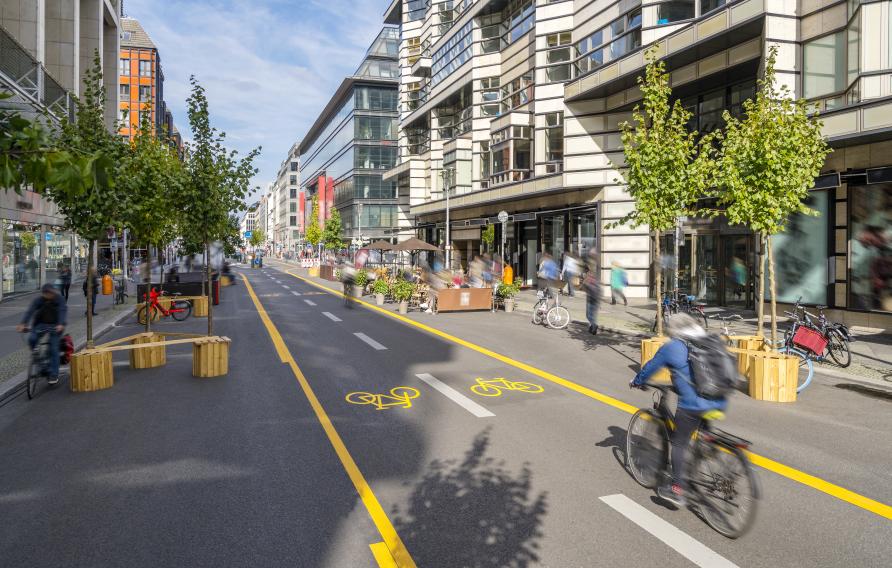 Pop-up bicycle lane in central Berlin with people biking, walking and relaxing. This is a trial concept for urban planning which improves the quality of life of people.