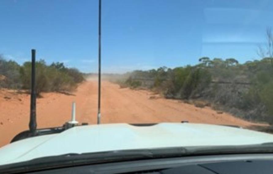 View of the desert and blue sky from a dashboard